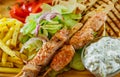 Greek Chicken Souvlaki with salad, french fries potato, pita and tzatziki sauce Royalty Free Stock Photo