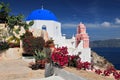 Greek church with blue dome and pink bell tower, Oia, Santorini Thira, Cyclades Islands, Greek Islands, Greece, Europe Royalty Free Stock Photo