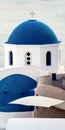 A Greek Church in Santorini with a blue dome and cross an the top Royalty Free Stock Photo