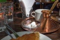 Greek coffee copper pot on a tray.