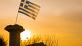 Greek column and flag at sunrise, Cape Sounio