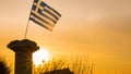 Greek column and flag at sunrise, Cape Sounio