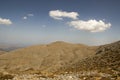 Greek Crete mountain range with highest mountain Ida Psiloritis, very dry hard terrain with sharp rocks and stones, white clouds