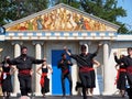 Greek Dancers Against Greek Architecture Royalty Free Stock Photo