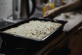 Greek dish in a baking tray standing on the stove