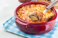 Greek dish moussaka made in a traditional ceramic pot, horizontal, copy space