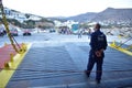 A greek ferry boat prepares to dock at the charming island of Sikinos.  Travellers at the dock prepare to board. Royalty Free Stock Photo