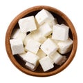 Greek Feta cheese cubes in wooden bowl over white