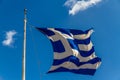 Greek flag against blue sky Royalty Free Stock Photo