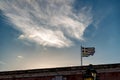 Greek flag against Sun at sunset, scenery clouds Royalty Free Stock Photo