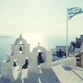 Greek flag and bell tower in Oia village, Santorini, Greece Royalty Free Stock Photo