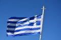 Greek flag against a cloudless blue sky Royalty Free Stock Photo