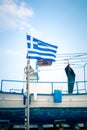 Greek Flag, Blue Sky And Greek Fishing Boat In The Background In Royalty Free Stock Photo