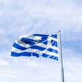 Greek flag and cloudy sky in summer day, politics of Europe