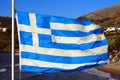 Greek flag fluttering in the wind of the famous Cyclades islands in the heart of the Aegean Sea Royalty Free Stock Photo