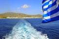 Greek flag fluttering in the wind of Tinos, famous Cyclades island in the heart of the Aegean Sea Royalty Free Stock Photo