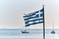 Greek flag flying against blue sea and sky, Santorini, Greece Royalty Free Stock Photo