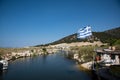 Greek flag flying over the river channel