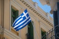 The Greek flag hangs from a balcony Royalty Free Stock Photo