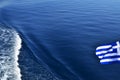 Greek flag over sea waters Royalty Free Stock Photo