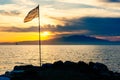Greek flag, seashore, sunset Royalty Free Stock Photo