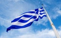 Greek flag waving against blue sky Royalty Free Stock Photo