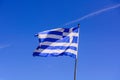 Greek flag waving on the blue sky background. National symbol of Greece, waving flag. Royalty Free Stock Photo