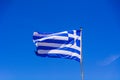 Greek flag waving on the blue sky background. National symbol of Greece, waving flag. Royalty Free Stock Photo