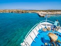 Greek flag waving on the bow of a boat sailing toward the island of Chrissi or the Caribbean in Greece