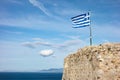 Greek flag waving in breeze at the stone walls of the Patras Castle Royalty Free Stock Photo