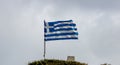 Greek flag waving against cloudy sky background Royalty Free Stock Photo