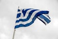 Greek flag waving on a flag pole against the sky Royalty Free Stock Photo