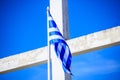 Greek Flag On A White Cross And Blue Sky Background