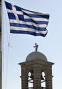 Greek flag waving in the wind and church with a cross on top Lycabettus hill Athens Greece Royalty Free Stock Photo