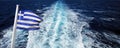 Greek flag waving in the wind with the Cyclades sea as a background Royalty Free Stock Photo