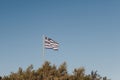 Greek flag in the wind, against blue sky Royalty Free Stock Photo