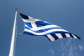 Greek flag in the wind against a blue Summer sky Royalty Free Stock Photo