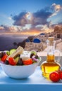 Greek food against famous churches in Oia village on Santorini island in Greece Royalty Free Stock Photo