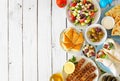 Greek food double border, overhead view on a white wood background Royalty Free Stock Photo