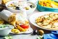 Greek food: salad, chicken souvlaki, gyros and baked potatoes on gray background. Traditional greek cuisine concept