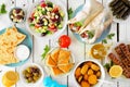 Greek food table scene, above view on a white wood background Royalty Free Stock Photo