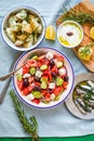 Greek food table scene, top view . Variety of items including greece salad, cucumber dip Tzatziki, Anchovy fillets, lemon potatoes Royalty Free Stock Photo