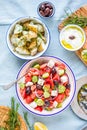 Greek food table scene, top view . Variety of items including greece salad, cucumber dip Tzatziki, Anchovy fillets, lemon potatoes Royalty Free Stock Photo