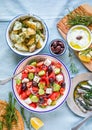 Greek food table scene, top view . Variety of items including greece salad, cucumber dip Tzatziki, Anchovy fillets, lemon potatoes Royalty Free Stock Photo
