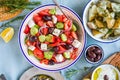 Greek food table scene, top view . Variety of items including greece salad, cucumber dip Tzatziki, Anchovy fillets, lemon potatoes Royalty Free Stock Photo