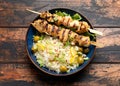 Greek grilled chicken skewers served with lemon rice and marinated green olives Royalty Free Stock Photo