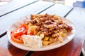 Greek gyros with french fries, vegetables and tzatziki sauce on white plate Royalty Free Stock Photo