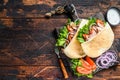 Greek gyros wrapped in pita breads with vegetables and sauce. Dark wooden background. Top view. Copy space Royalty Free Stock Photo