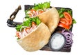 Greek gyros wrapped in pita breads with vegetables and sauce. Isolated on white background, top view. Royalty Free Stock Photo