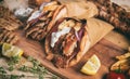 Greek gyros wrapped in pita breads on a wooden table Royalty Free Stock Photo